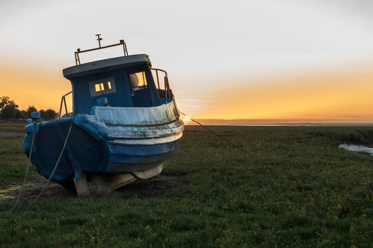 Old fishing boat at sunset in the Gower