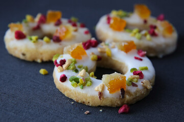 shortbread cookies with candied fruits on a dark background
