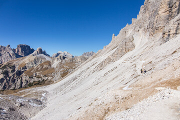 Hiking trail at the Tre Cime di Lavadero area in the italian Dolomites mountains on a beautiful autumn day