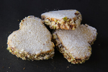 three shortbread cookies on a dark background, top view