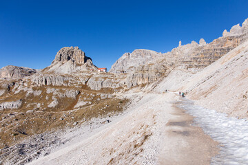 Hiking trail at the Tre Cime di Lavadero area in the italian Dolomites mountains on a beautiful autumn day