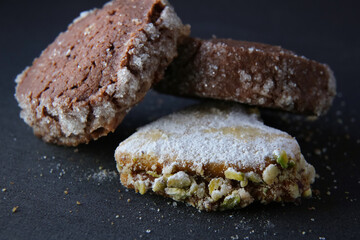 three shortbread cookies on a dark background, top view
