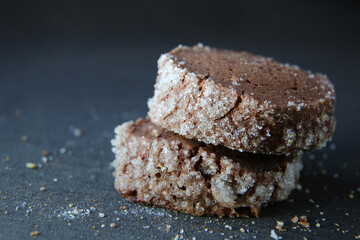 chocolate shortbread cookies on a dark background