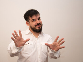 Young man with beard showing the palm of his hands