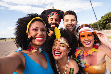 Carnival Party in Brazil, portrait of young people having fun at fest event dressed.