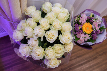 Lots of white rose. Bouquets of roses are congratulatory.