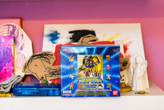 Hamburg, Germany - 12262021: picture of a sealed english Digimon display card box from the Classic Collection EX01 series standing in childs room.