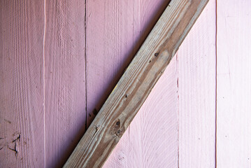 several vintage wooden boards painted in pink. Wooden beams used for the exterior of houses in the Caribbean.