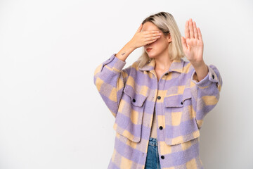 Young caucasian woman isolated on white background making stop gesture and covering face