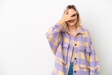 Young caucasian woman isolated on white background covering eyes by hands and smiling