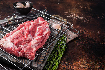 Ready for cooking on grill Boneless lamb meat, raw neck meat with herbs. Dark background. Top view. Copy space