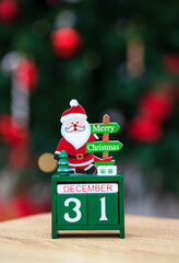 Wooden calendar with date 31 December on bokeh background