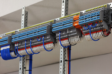 1-level and 3-level colored electrical terminals with connected mounting wires located on the din...