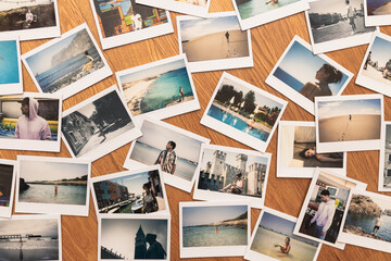 Naklejka premium Beautiful holiday collage made of many photos. Printed pictures of holidays. Printed photos on wooden background