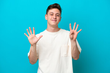 Young handsome Brazilian man isolated on blue background counting nine with fingers