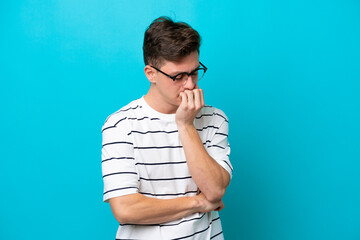 Young handsome Brazilian man isolated on blue background having doubts