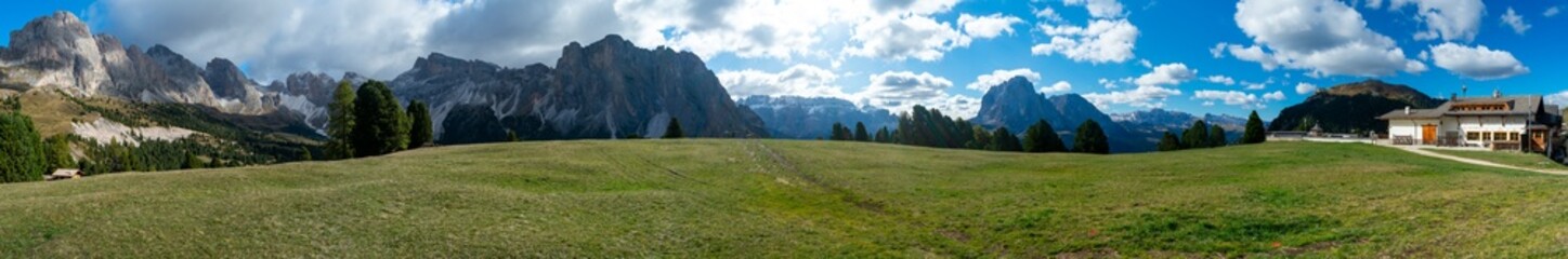 Fototapeta na wymiar Hiking Dolomites in European Alps. Shot in summer with green grass and no snow. Gardena Pass, Italy