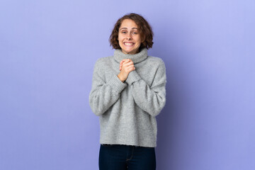 Young English woman isolated on purple background laughing