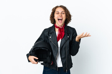 English woman holding a motorcycle helmet isolated on white background with shocked facial expression