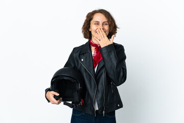 Fototapeta premium English woman holding a motorcycle helmet isolated on white background happy and smiling covering mouth with hand