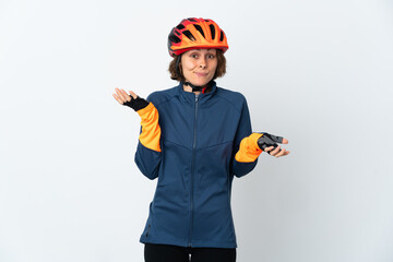 Young English cyclist woman isolated on white background having doubts while raising hands