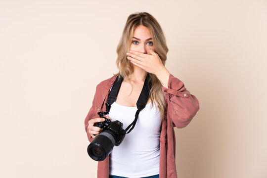 Young photographer girl over isolated background covering mouth with hands