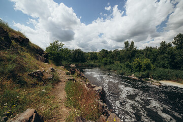 Small waterfall surrounded by green trees and rocks