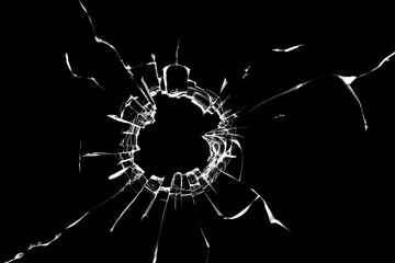 Photo effect of broken glass, a hole with cracks in the glass on a dark background.