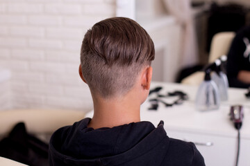 Male head with stylish haircut on barbershop background