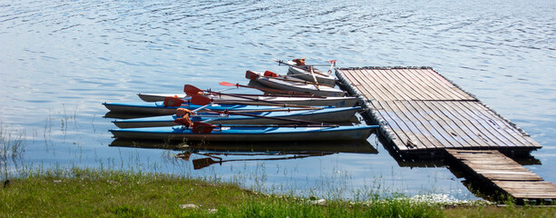 rowing boats stranded on the edge of a lake