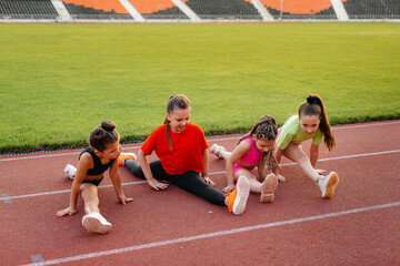 The girls are engaged in warm-up exercises and exercises in gymnastics and acrobatics in the summer...