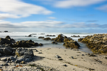 Long exposure photography of Pacific Ocean waves against rocky coast of California