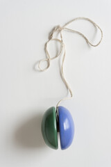 two toned yo-yo with grungy string on a light background