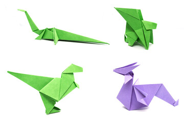 Set of beautiful origami green, violet dinosaurs, dragons isolated on white background. Paper craft.