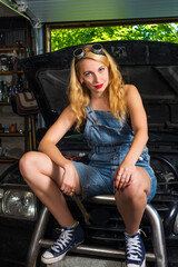 Fototapeta na wymiar girl auto mechanic in garage
