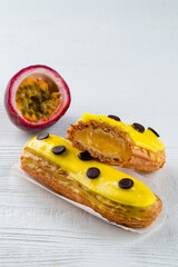 Beautiful and tasty eclair with yellow glaze and mango-passion fruit flavor