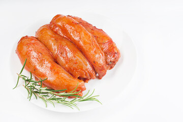 Fresh marinated chicken meat.Raw marinated chicken fillet in red sauce on a white plate on a light...