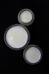 Fresh milk in jar on black background.