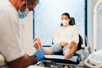 Chiropodist exploring a patient with diabetic foot in the medical center. - obrazy, fototapety, plakaty