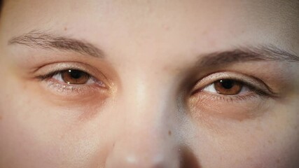 Close up of face of angry Arab woman. Annoyed girl squinting with brown eyes. Macro portrait of female middle eastern Muslim model looking mean and frustrated at camera. 4K. - Powered by Adobe