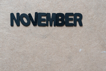 the month of november in black chalk letter 