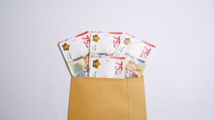 Indonesian Rupiah the official currency of Indonesia. Business and finance concept, Uang 75000...