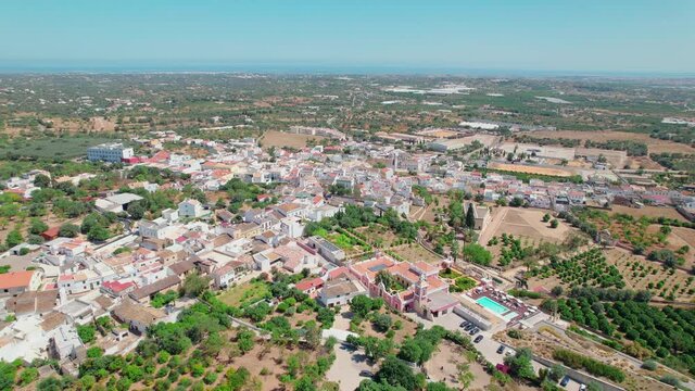 Portuguese historical village on a sunny day with traditional houses from above. Roman Ruins of Milreu and Estoi Palace / Pousada Pal&aacute;cio Est&oacute;i Resort Hotel with pool in 4K. 