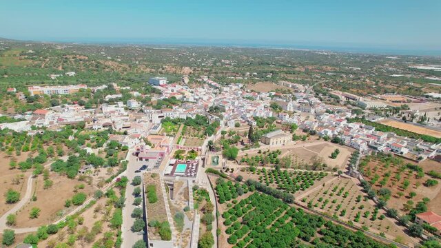 Portuguese historical village on a sunny day with traditional houses from above. Roman Ruins of Milreu and Estoi Palace / Pousada Pal&aacute;cio Est&oacute;i Resort Hotel with pool in 4K. 
