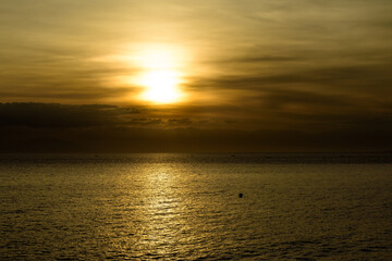 Fototapeta na wymiar Beautiful sunset with glistening seas and romantic clouds. 