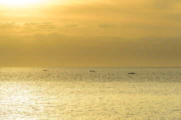 Beautiful sunset with glistening seas and romantic clouds. 