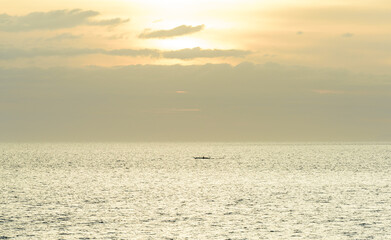 A gorgeous sunset over the Pacific Ocean with silhouette shots of fishing boats. 
