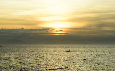 A gorgeous sunset over the Pacific Ocean with silhouette shots of fishing boats. 