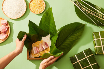 Vietnamese traditional Chung cake with dong leaf pork glutinous rice in green background for...