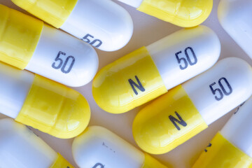 A macro close up to white and yellow N 50 capsules